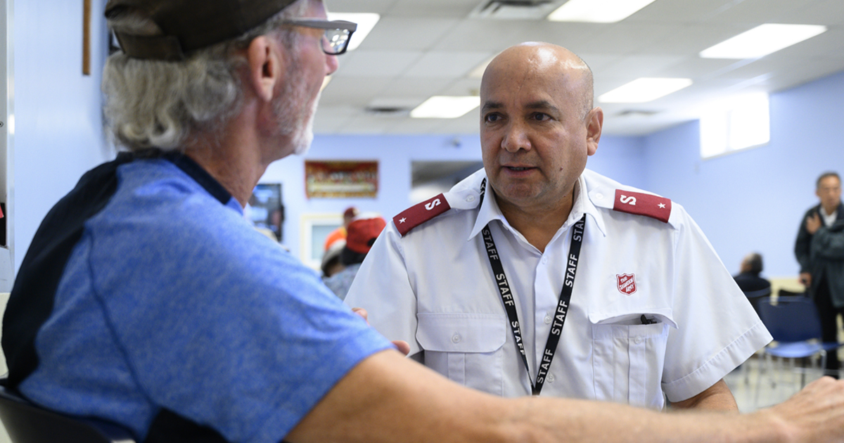 A Salvation Army officer speaks with a man