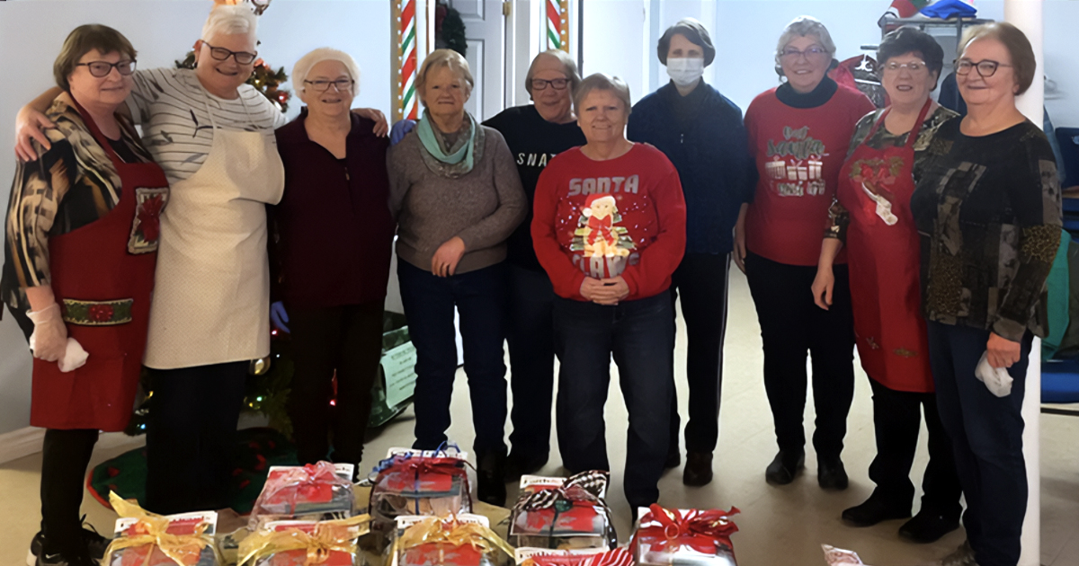 A group of smiling women dressed up for Christmas