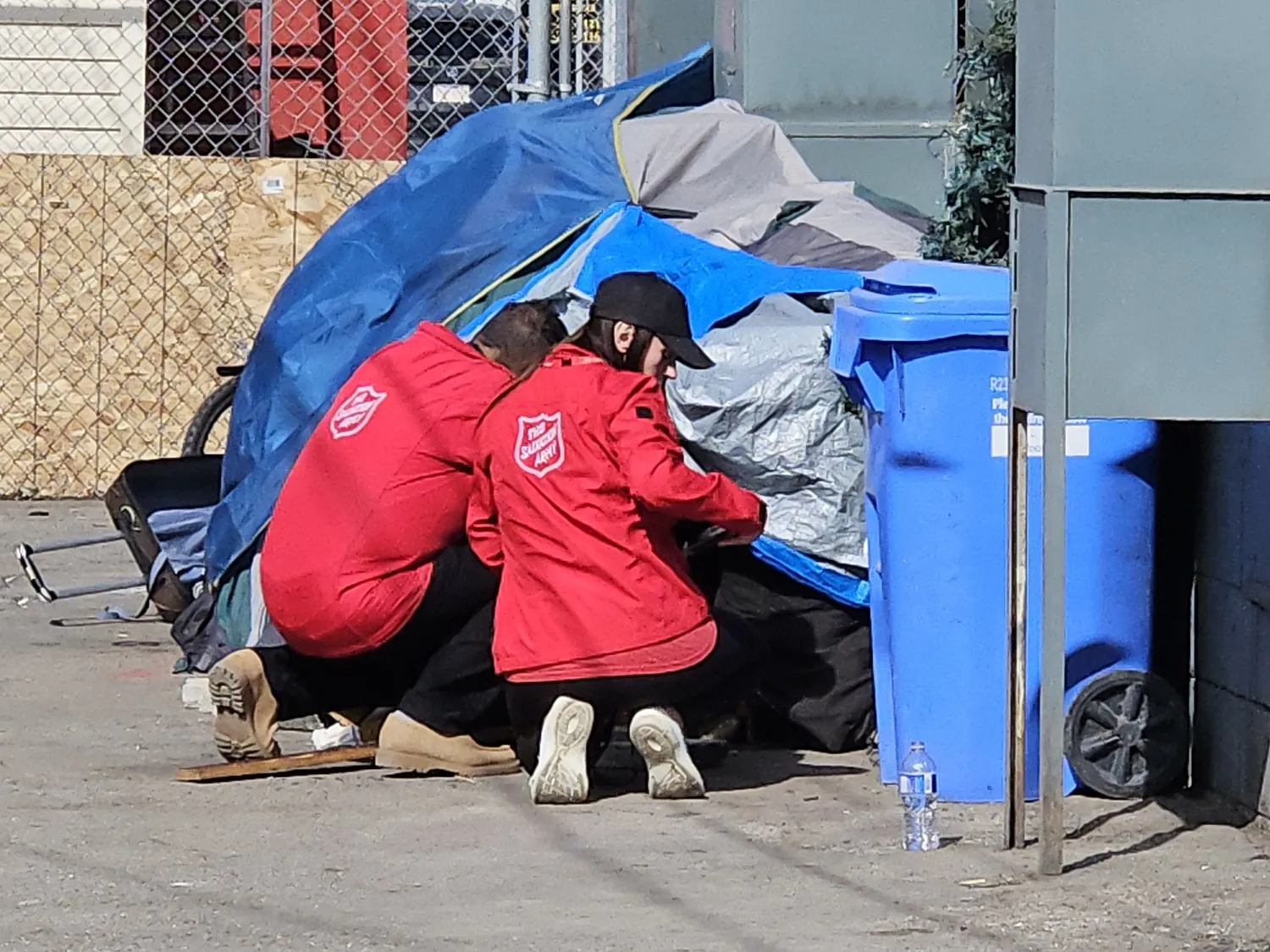 outreach volunteers on street beside tent